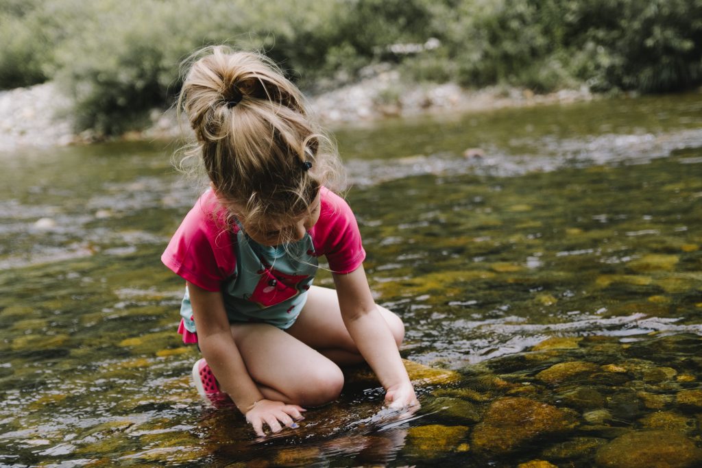 girl playing in a stream